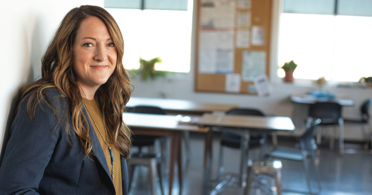 school leader in front of classroom image